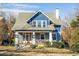Charming blue two-story home with white trim and a wraparound porch at 807 E Edenton St, Raleigh, NC 27601