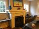 Cozy living room with a fireplace and built-in workspace at 807 E Edenton St, Raleigh, NC 27601