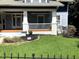 Well-manicured lawn with stone wall and black metal fence at 807 E Edenton St, Raleigh, NC 27601