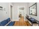 Hallway with hardwood floors, navy chairs, and a view into a bedroom at 807 E Edenton St, Raleigh, NC 27601