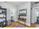 Bright hallway with artwork, a console table, and access to a bathroom at 807 E Edenton St, Raleigh, NC 27601