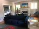 Spacious living room with a navy sofa, dining area, and fireplace at 807 E Edenton St, Raleigh, NC 27601