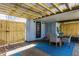 Covered patio with dining table, chairs, and blue rug at 807 E Edenton St, Raleigh, NC 27601