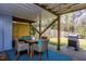 Covered patio with outdoor dining set and gas grill at 807 E Edenton St, Raleigh, NC 27601