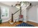 Grand staircase with dark wood railings and a stained glass light fixture at 807 E Edenton St, Raleigh, NC 27601