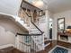 Grand staircase with white railings and gallery wall at 921 Vance, Raleigh, NC 27608