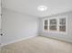 Spacious bedroom with neutral carpeting and large windows at 99 Prairie Dog Dr, Louisburg, NC 27549