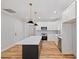 Modern kitchen with white shaker cabinets, quartz countertops, and a dark island at 99 Prairie Dog Dr, Louisburg, NC 27549