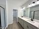 Main bathroom with double vanity, modern fixtures and a walk-in shower at 100 S Stonemill Trl # Homesite 234, Clayton, NC 27520