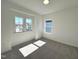 Well-lit bedroom featuring carpet and two large windows at 100 S Stonemill Trl # Homesite 234, Clayton, NC 27520
