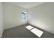 Bright bedroom with neutral carpet and a window at 100 S Stonemill Trl # Homesite 234, Clayton, NC 27520