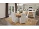 Kitchen and dining area with round wooden table, white chairs, and modern light fixtures at 100 S Stone Mill E Trl # 234, Clayton, NC 27520