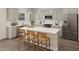 Modern kitchen with light-green cabinets, a large island, and stainless steel appliances at 100 S Stonemill Trl # Homesite 234, Clayton, NC 27520