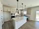Modern kitchen with island, stainless steel appliances, and light cabinets at 100 S Stonemill Trl # Homesite 234, Clayton, NC 27520