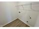 Bright laundry room with wire shelving and vinyl flooring at 100 S Stonemill Trl # Homesite 234, Clayton, NC 27520