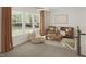Cozy living room featuring a brown sofa and large windows at 100 S Stonemill Trl # Homesite 234, Clayton, NC 27520