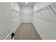 Spacious walk-in closet with wire shelving and neutral carpeting at 100 S Stonemill Trl # Homesite 234, Clayton, NC 27520