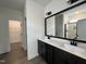 Modern bathroom features a double vanity, a large mirror, and a tiled shower at 107 Pretty Run Branch Ln, Wendell, NC 27591