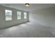 Bright bedroom featuring three windows allowing for ample sunlight at 107 Pretty Run Branch Ln, Wendell, NC 27591