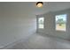 A bright bedroom featuring two windows for ample sunlight at 107 Pretty Run Branch Ln, Wendell, NC 27591