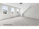 This light-filled bedroom has three windows, neutral carpet, and an angled wall at 107 Pretty Run Branch Ln, Wendell, NC 27591