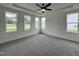 Spacious bedroom with natural light features a ceiling fan and neutral carpet at 107 Pretty Run Branch Ln, Wendell, NC 27591