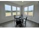 Bright dining area with large windows offering scenic views, table, and wood-look flooring at 107 Pretty Run Branch Ln, Wendell, NC 27591