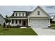 Charming home featuring a two-car garage, a well-manicured lawn, and a classic design at 107 Pretty Run Branch Ln, Wendell, NC 27591