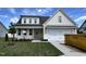 Charming new construction home with a two-car garage, manicured lawn, and inviting front entrance at 107 Pretty Run Branch Ln, Wendell, NC 27591