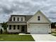 Charming two-story home featuring a two-car garage, front porch and neutral color palette at 107 Pretty Run Branch Ln, Wendell, NC 27591