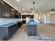 Modern kitchen featuring stylish gray cabinets, stainless steel appliances, and a central island at 107 Pretty Run Branch Ln, Wendell, NC 27591