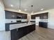 Modern kitchen with stainless steel appliances, granite countertops and a large island at 107 Pretty Run Branch Ln, Wendell, NC 27591