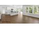 Open-concept kitchen boasts stainless appliances, a central island, and an abundance of natural light at 107 Pretty Run Branch Ln, Wendell, NC 27591