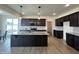 Spacious kitchen with dark cabinets, granite countertops and a large center island at 107 Pretty Run Branch Ln, Wendell, NC 27591