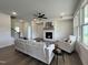 Spacious living room featuring hardwood floors, a fireplace, lots of natural light, and a modern ceiling fan at 107 Pretty Run Branch Ln, Wendell, NC 27591