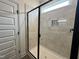 Contemporary tiled shower with a glass door and a built-in niche at 107 Pretty Run Branch Ln, Wendell, NC 27591