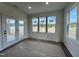 Bright sun room with large windows, French doors and scenic backyard views, perfect for relaxation at 107 Pretty Run Branch Ln, Wendell, NC 27591