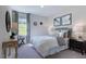 Comfortable bedroom with a king-size bed and window seat at 109 Magma Ln, Holly Springs, NC 27540