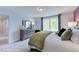 Bright bedroom with a dresser, large bed, and plenty of natural light at 109 Magma Ln, Holly Springs, NC 27540