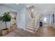 Light and airy entryway with hardwood floors and staircase at 109 Magma Ln, Holly Springs, NC 27540