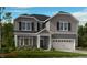 Two-story home with gray siding, white trim, and a two-car garage at 109 Magma Ln, Holly Springs, NC 27540