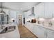 Modern kitchen with white cabinets, island, and stainless steel appliances at 109 Magma Ln, Holly Springs, NC 27540