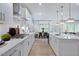 Modern kitchen with white cabinets, island, and stainless steel appliances at 109 Magma Ln, Holly Springs, NC 27540