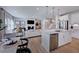 Open concept kitchen with island, stainless steel appliances, and white cabinetry at 109 Magma Ln, Holly Springs, NC 27540