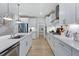 Modern kitchen with white cabinets, island, and stainless steel appliances at 109 Magma Ln, Holly Springs, NC 27540