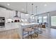 Modern kitchen with white cabinets, island, and stainless steel appliances at 109 Magma Ln, Holly Springs, NC 27540