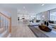 Open living area with hardwood floors and a view of the kitchen at 109 Magma Ln, Holly Springs, NC 27540