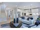 Light and airy living room with hardwood floors and comfy seating at 109 Magma Ln, Holly Springs, NC 27540