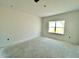 Simple bedroom with a window and neutral walls at 121 S Stone Mill W Trl # 240, Clayton, NC 27520