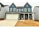 Newly built two-story home with blue siding and a two-car garage at 121 S Stone Mill W Trl # 240, Clayton, NC 27520